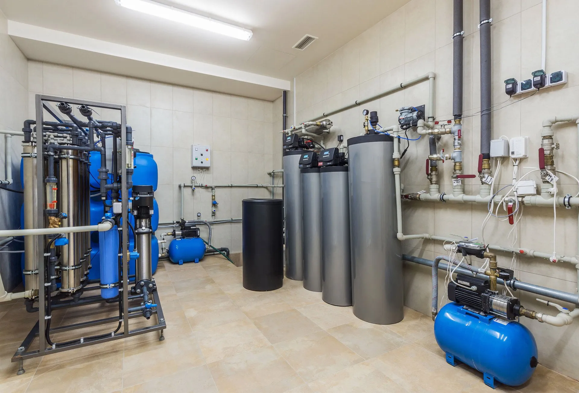 A room with many water filters and pipes