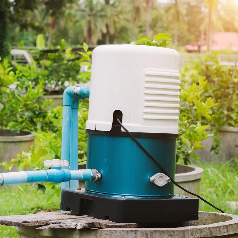 A blue and white water pump sitting on top of a wooden table.